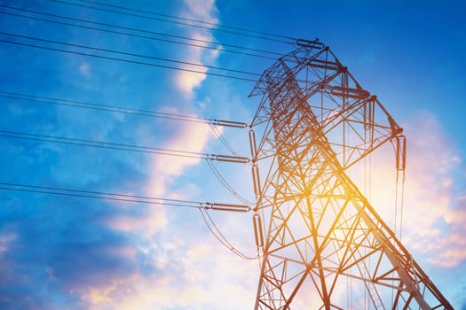 High voltage pole on blue sky background. High voltage tower.