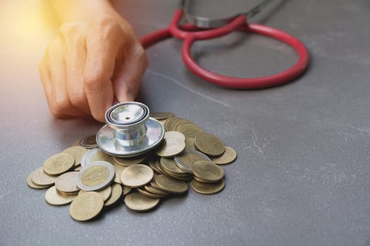 Stethoscope with Coins in jar with money stack, Concept finance, accounting, business and saving investment.