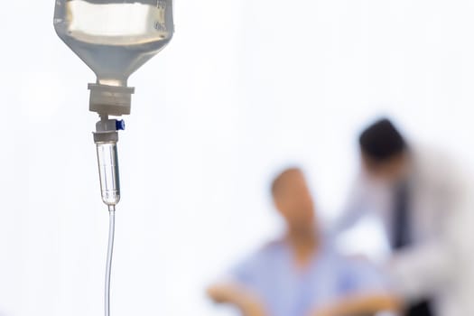 Set iv fluid intravenous drop saline drip in hospital room with patient and doctor in background