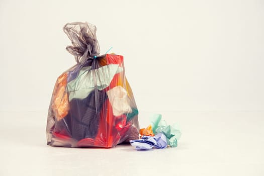 garbage bag with defferent content  in front of light background