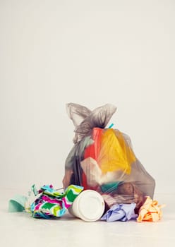 garbage bag with defferent content  in front of light background