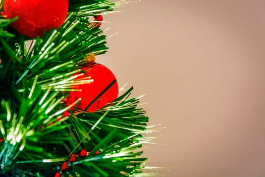 Christmas tree decorated with red balls and led lights. Holidays and vacations