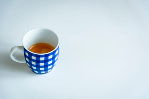 A cup of coffee with blue stripes isolated with a white background