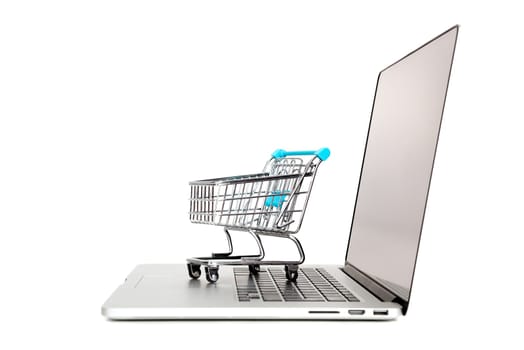 Laptop with small shopping cart isolated in white