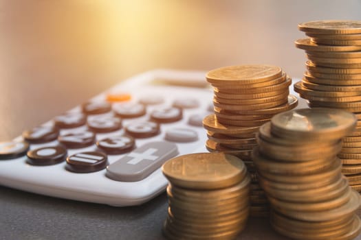 Saving money concept with money coin stack growing and calculator for business and accounting concept.