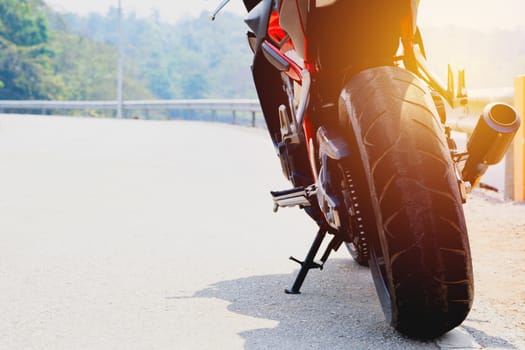 A motorcycle parking on the road right side and copy space for text.