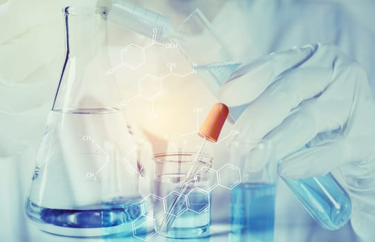 Researcher with glass laboratory chemical test tubes with liquid for analytical , medical, pharmaceutical and scientific research concept.