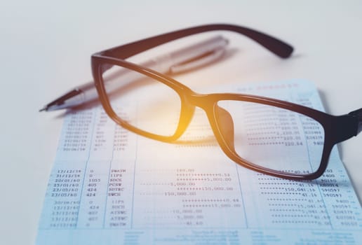 Glasses with bank account passbook for savings financial and accounting concept.
