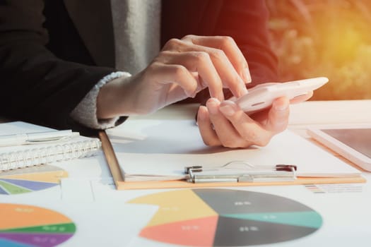 Businesswoman using calculator with stock financial indices with stack coin. Financial stock market in accounting market economy analysis.