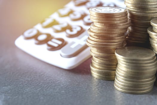 Saving money concept with money coin stack growing and calculator for business and accounting concept.