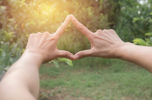 Close up of hands making frame gesture. Close up of woman hands making frame gesture with sunset.