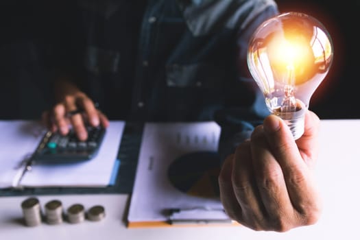 Hand of male holding a light bulb for innovation and creative concept .