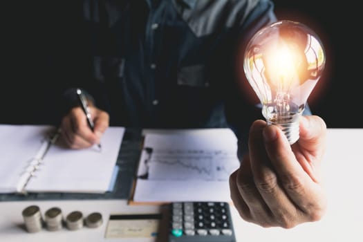 Hand of male holding a light bulb for innovation and creative concept .