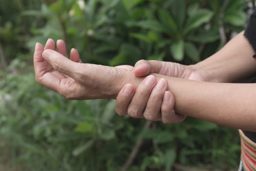 Female holding wrist. Pain in a woman wrist. Woman massaging painful wrist. pain concept.