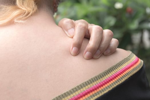 Women scratch itch with hand. Woman scratching her neck healthcare concept.