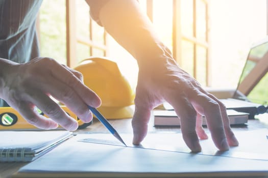 Architect engineer working concept and construction tools or safety equipment on table.