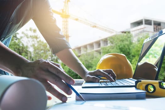 Architect engineer working concept and construction tools or safety equipment on table.