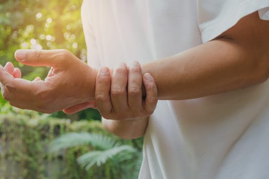 Male holding wrist. Pain in a man wrist. Man massaging painful wrist. pain concept.