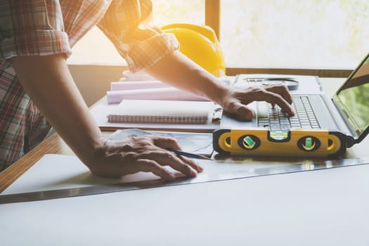 Architect engineer working concept and construction tools or safety equipment on table.