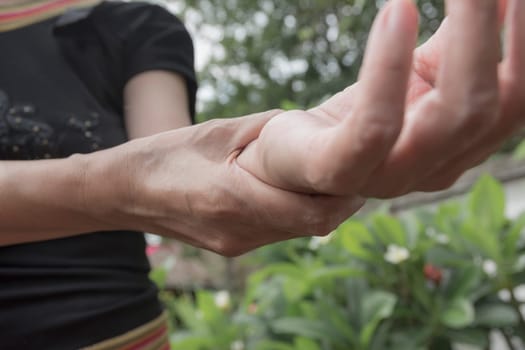 Female holding wrist. Pain in a woman wrist. Woman massaging painful wrist. pain concept.