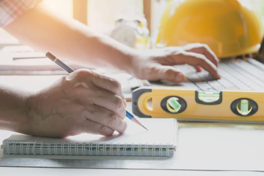 Architect engineer working concept and construction tools or safety equipment on table.