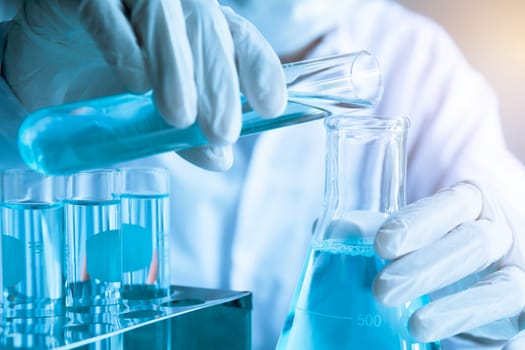 Researcher with glass laboratory chemical test tubes with liquid for analytical , medical, pharmaceutical and scientific research concept.