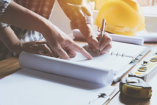 Architect engineer working concept and construction tools or safety equipment on table.