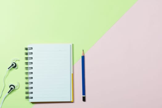 Top view of pencil and notebook on colorful background and copy space for insert text.