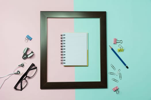 Top view of pencil with other school supplies and notebook on colorful background and copy space for insert text.