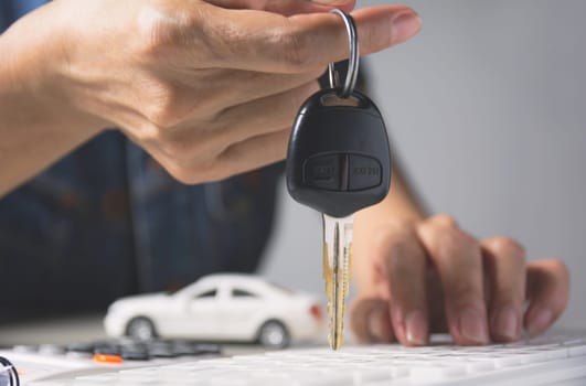 Car insurance and car service. Businesswoman and toy car, business and financial concept.