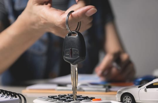 Car insurance and car service. Businesswoman and toy car, business and financial concept.