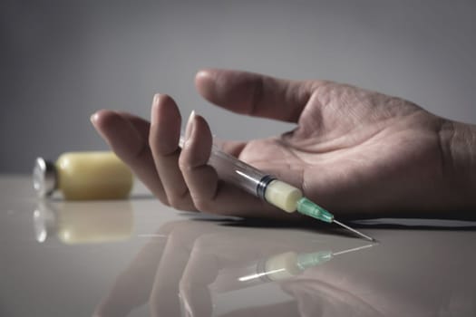 The man committing suicide by overdosing on medication. Close up of overdose pills and addict.