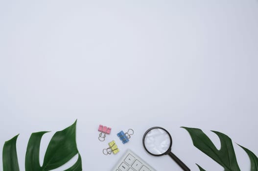 Top view of office supplies and notebook on white background and copy space for insert text.