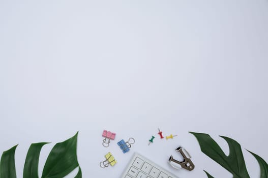 Top view of office supplies and notebook on white background and copy space for insert text.