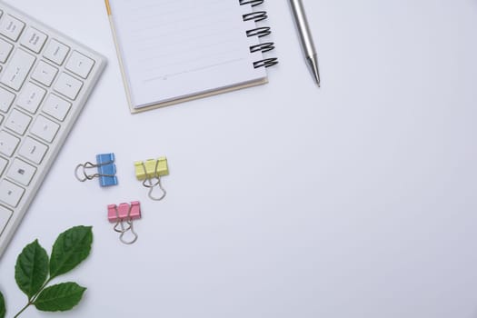 Top view of office supplies and notebook on white background and copy space for insert text.