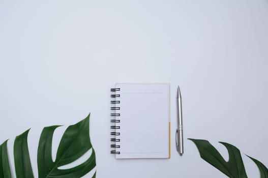 Top view of open book. Book open with pen on white background and copy space for insert text.