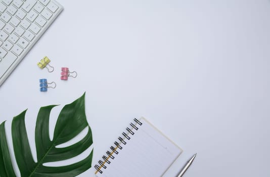 Top view of office supplies and notebook on white background and copy space for insert text.
