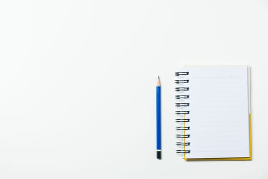 Top view of pencil and notebook isolated on white background and copy space for insert text.