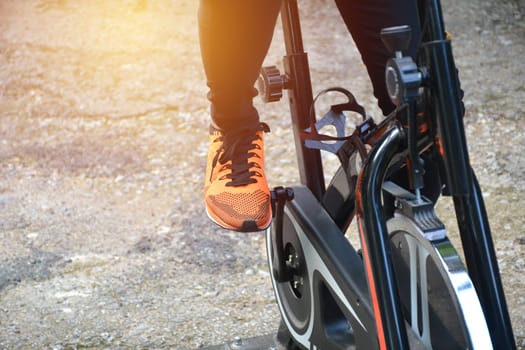 Female exercising on bicycle for exercising and healthy lifestyle concept.