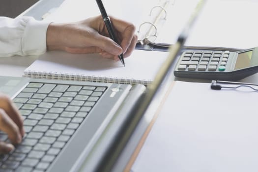 Person working and using a laptop for business and accounting concept.