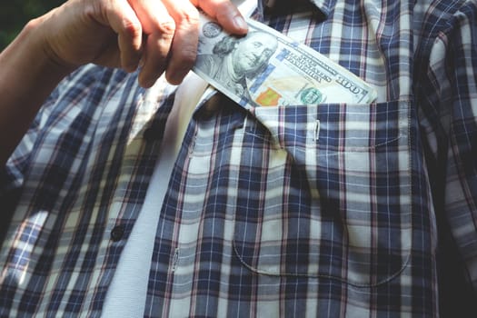Hand holding a banknote for financial, accounting and saving money concept.