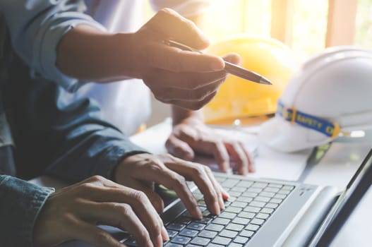 Architect engineer working concept with laptop and construction tools or safety equipment on table.