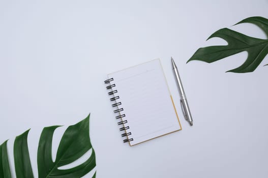 Top view of open book. Book open with pen on white background and copy space for insert text.