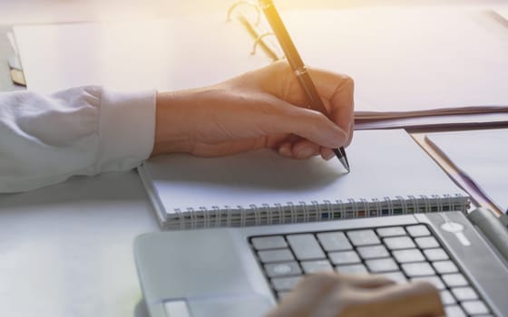 Businessman working and using a laptop for business and accounting concept.