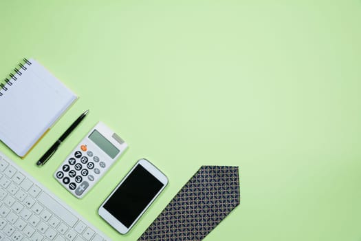 The office supplies on green background with copy space for insert text.