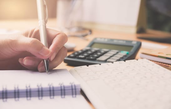 Businessman working and writing on notebook for working and people concept.