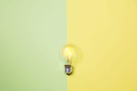 Top view of light bulb on colorful background and copy space for insert text.