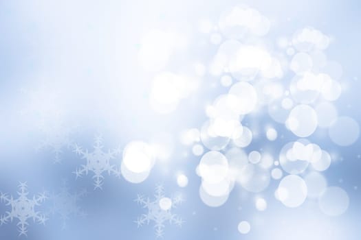 Abstract blurred festive winter christmas or Happy New Year background with shiny blue and white bokeh lighted snow landscape. Space for your design. Card concept.