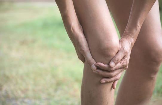 The female clings to a bad leg. The pain in her leg. Healthcare and painful concept.