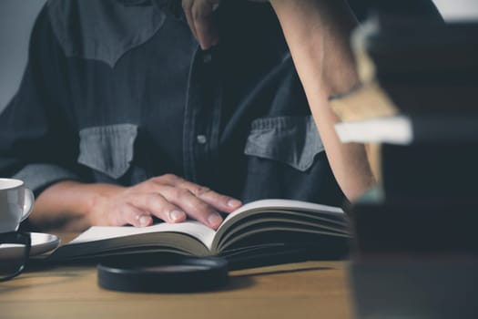 Man reading a book on the table. Education and people concept.